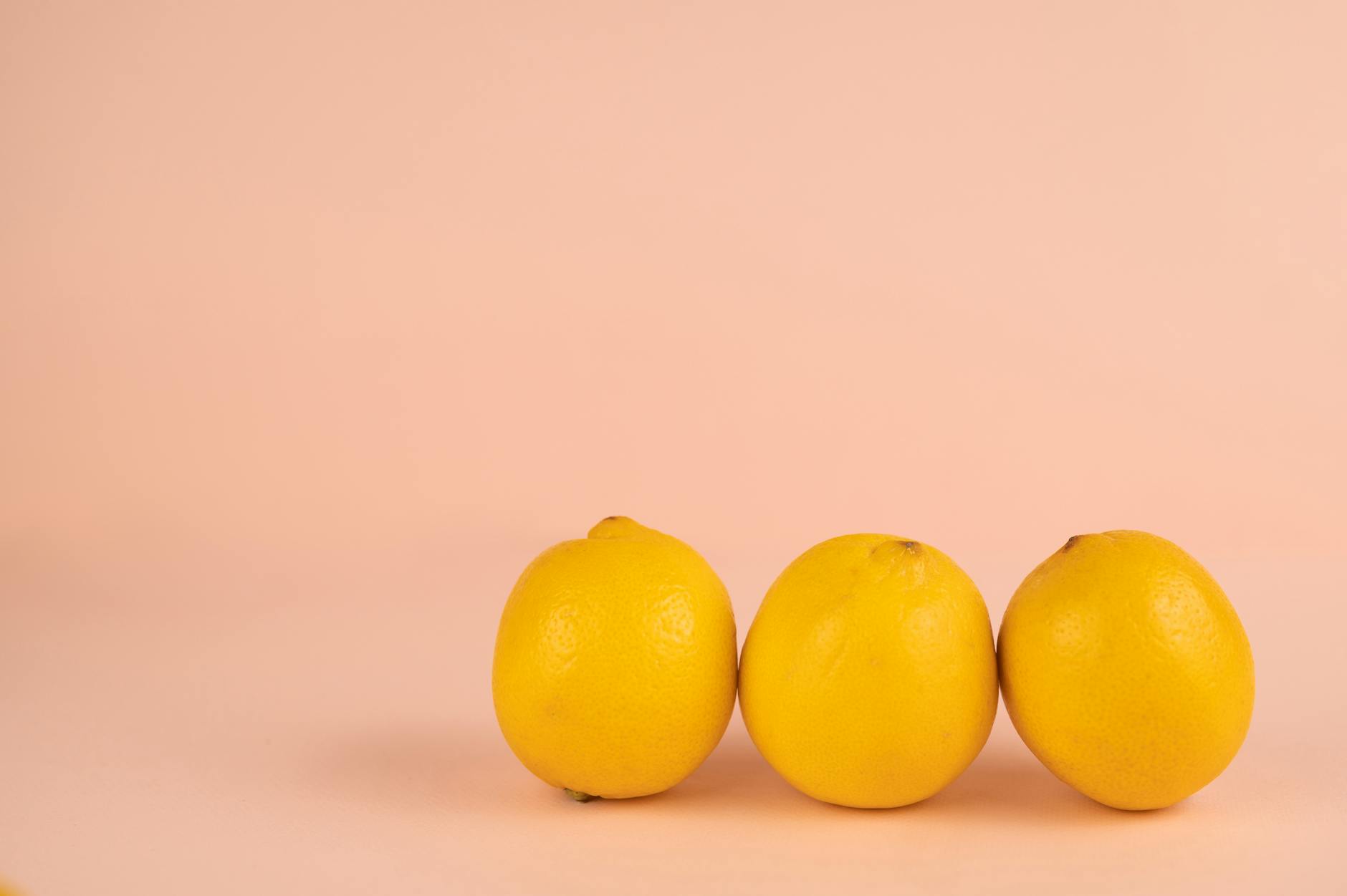 Fresh bright lemons arranged on a pastel background, symbolizing renewed vitality and sensation